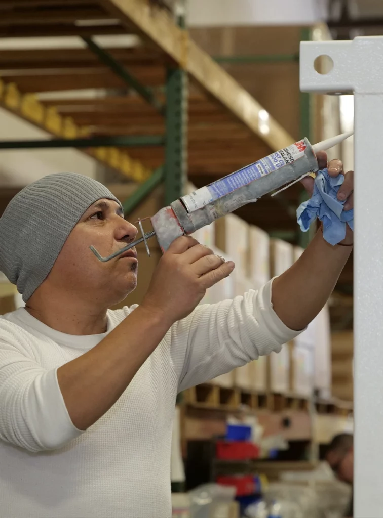 man putting epoxy on metal