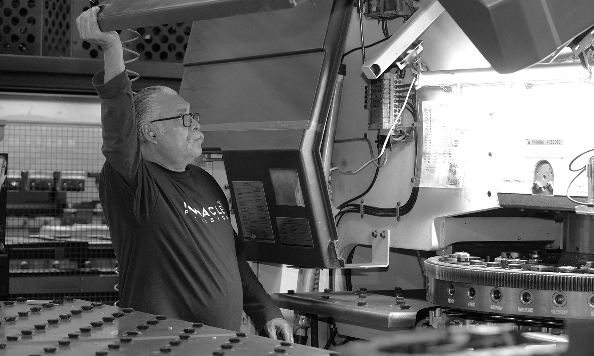 Man holding machine fabrication project - black and white photo